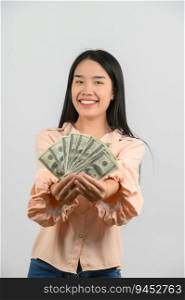 Portrait of a cheerful young woman holding money banknotes and celebrating isolated over white background. Finance, currency, payment and people concept.