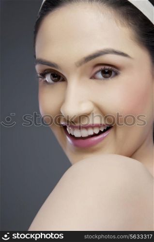 Portrait of a cheerful young woman over colored background
