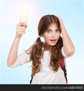 Portrait of a clever school girl with new idea, holding glowing lamp in hands, create a solution and resolve a problem concept, back to school