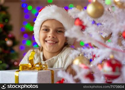 Portrait of a close-up of a beautiful girl with a New Year&rsquo;s gift