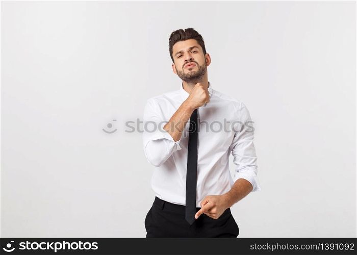 Portrait of a confident businessman in business cloth, fixing his tie. Portrait of a confident businessman in business cloth, fixing his tie.