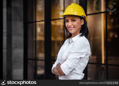 Portrait of a Confident Construction Engineer Woman. Smiling and Looking at Camera. Standing in front of the Modern Office Building