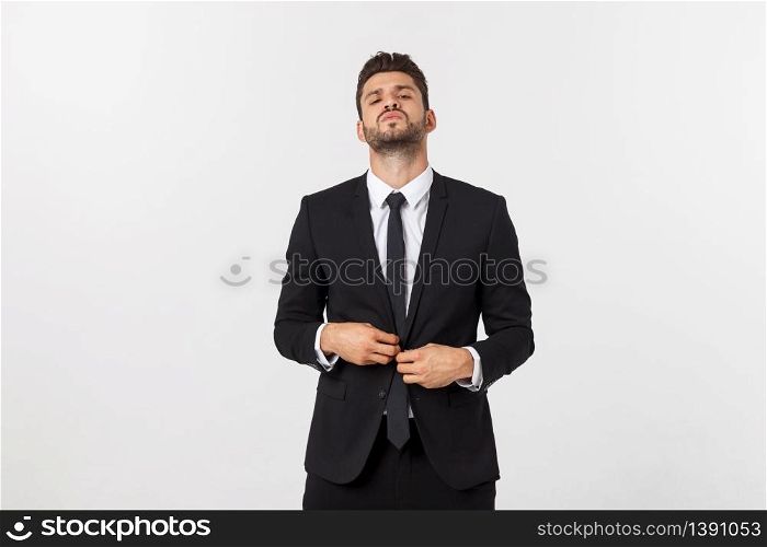 Portrait of a confident man in business suit, fixing his tie.. Portrait of a confident man in business suit, fixing his tie