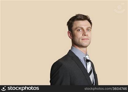 Portrait of a confident mid adult business professional over colored background
