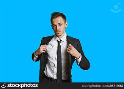 Portrait of a confident young businessman over colored background