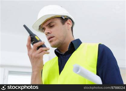 portrait of a contractor using walkie-talkie