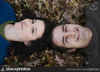 Portrait of a couple lying in a lawn