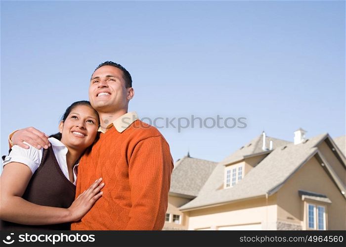 Portrait of a couple outside of a house