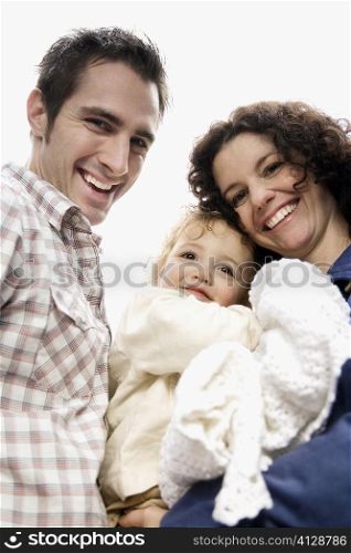 Portrait of a couple smiling with their daughter