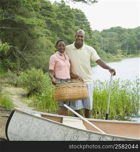 Portrait of a couple standing near a boat and smiling