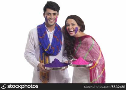 Portrait of a couple with holi colours enjoying