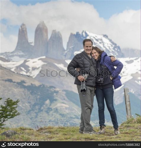 Portrait of a couple with mountain range in the background, Torres Del Paine National Park, Patagonia, Chile