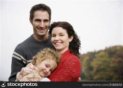 Portrait of a couple with their daughter