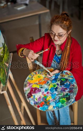 Portrait of a creative person in a working environment.. A woman artist in a creative setting 2935.
