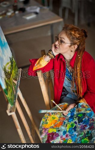 Portrait of a creative person in a working environment.. A woman artist in a creative setting 2936.