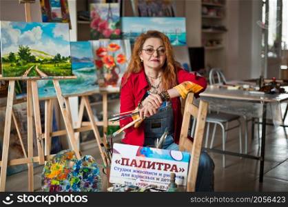 Portrait of a creative person in a working environment.. A woman artist in a creative setting 2939.