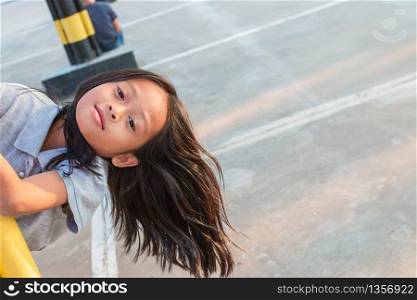 Portrait of a cute Asian girl at the mall parking lot