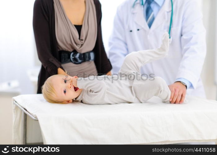 Portrait of a cute baby laying on table at pediatricians cabinet&#xA;