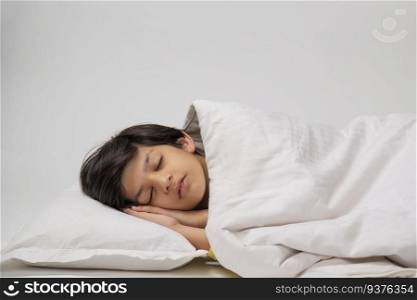 Portrait of a cute boy sleeping on bed