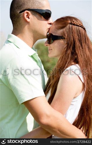 Portrait Of A Cute Couple Hugging, the men kiss the women