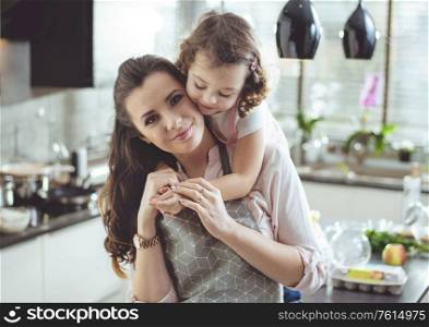 Portrait of a cute daughter hugging her beloved mother