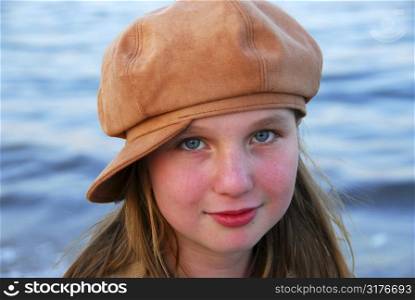 Portrait of a cute girl in suede hat