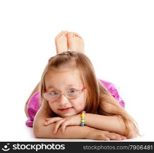 Portrait of a cute happy little girl in glasses laying on floor, isolated over white