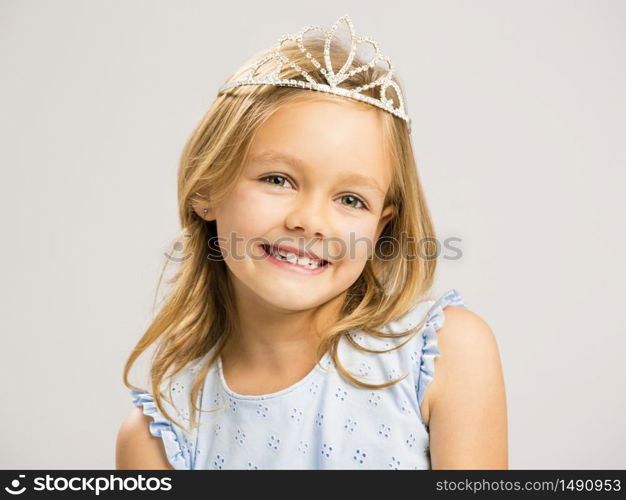 Portrait of a cute happy little girl wearing a princess crown