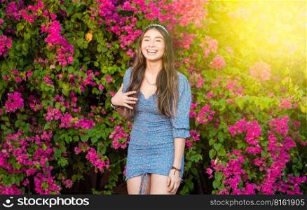 Portrait of a cute latin girl smiling in a garden, cute young brown latin girl smiling in the garden
