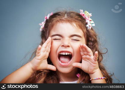 Portrait of a cute little baby girl screaming, naughty child yelling, expressing emotions, playful child rave about and making faces