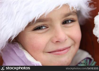 Portrait of a cute little girl by wintertime