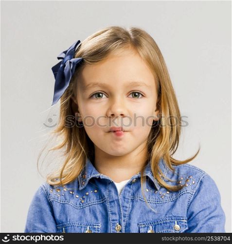 Portrait of a cute little girl making a fish mouth