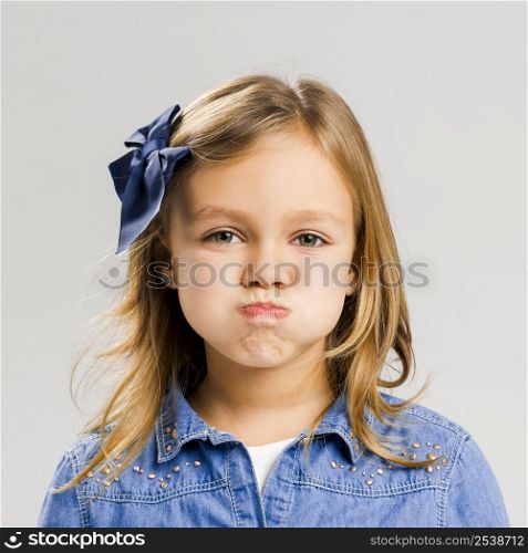 Portrait of a cute little girl with a annoyed expression