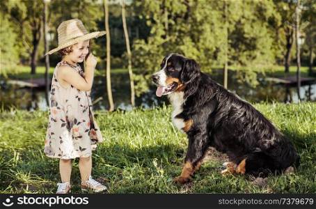 Portrait of a cute, little girl with a friendly dog