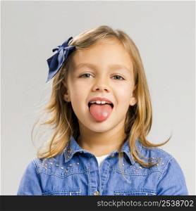 Portrait of a cute little girl with her tongue out