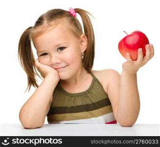 Portrait of a cute little girl with red apple, isolated over white
