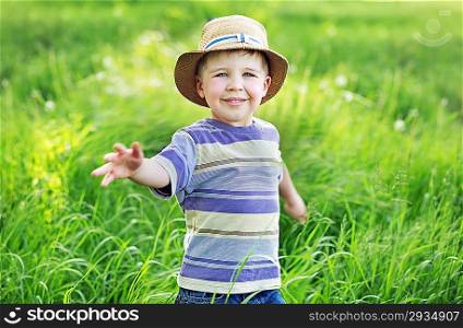 Portrait of a cute small kid playing on the meadow