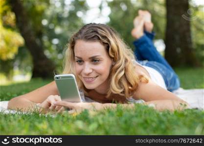 portrait of a cute woman laying on a grass