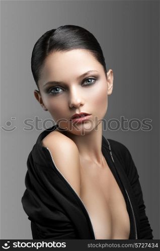 Portrait of a cute woman on a gray background