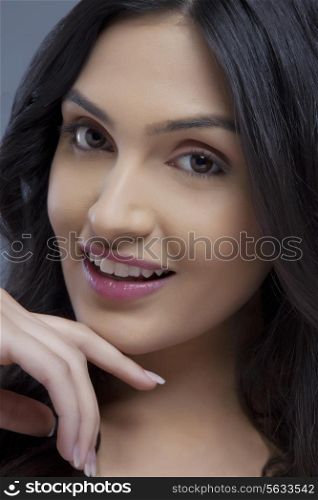 Portrait of a cute young female smiling over colored background