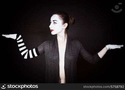 Portrait of a dancing woman mime on a black background