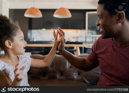 Portrait of a daughter and father having fun together at home. Monoparental concept.