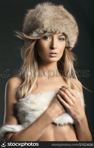 Portrait of a delicate blond woman wearing mink fur hat
