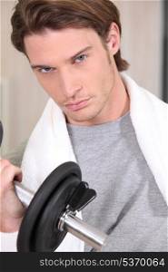Portrait of a determined man lifting a dumbbell