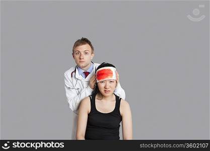 Portrait of a doctor treating his female patient