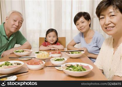 Portrait of a family sitting at a dining table