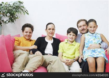 Portrait of a family sitting on a couch