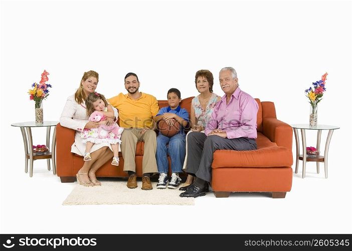 Portrait of a family sitting on couches and smiling