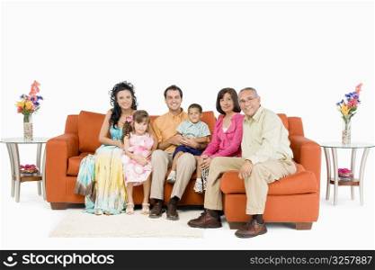Portrait of a family sitting on couches and smiling
