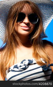 portrait of a fashionable long haired woman wearing hat